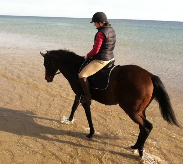 Leah Limone Dr. Leah Limone riding a horse on the beach